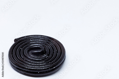 a rolled up licorice strap on white background photo