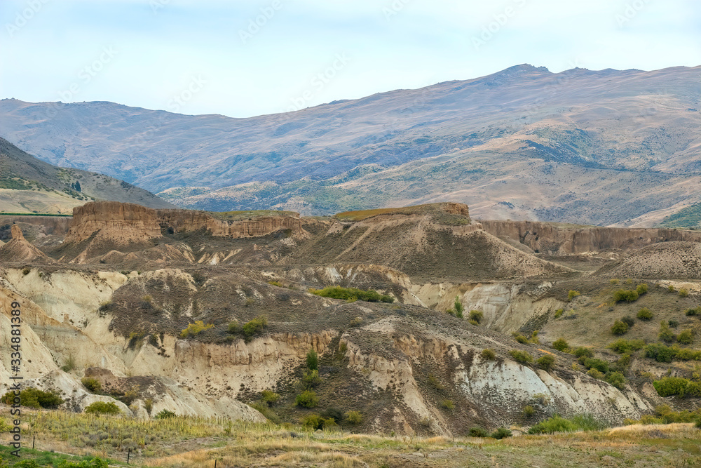 Fototapeta premium Hills Shaped by Water Hoses from Gold Mining in the Kawarau Gorge Area, near Queenstown, New Zealand