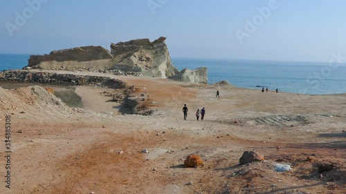 Wallpaper Mural Long shot of people walking toward the sea with a stunning landscape Torontodigital.ca