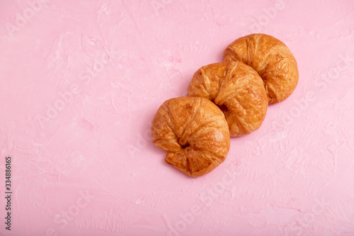 Croissants 3 pieces on the pink background