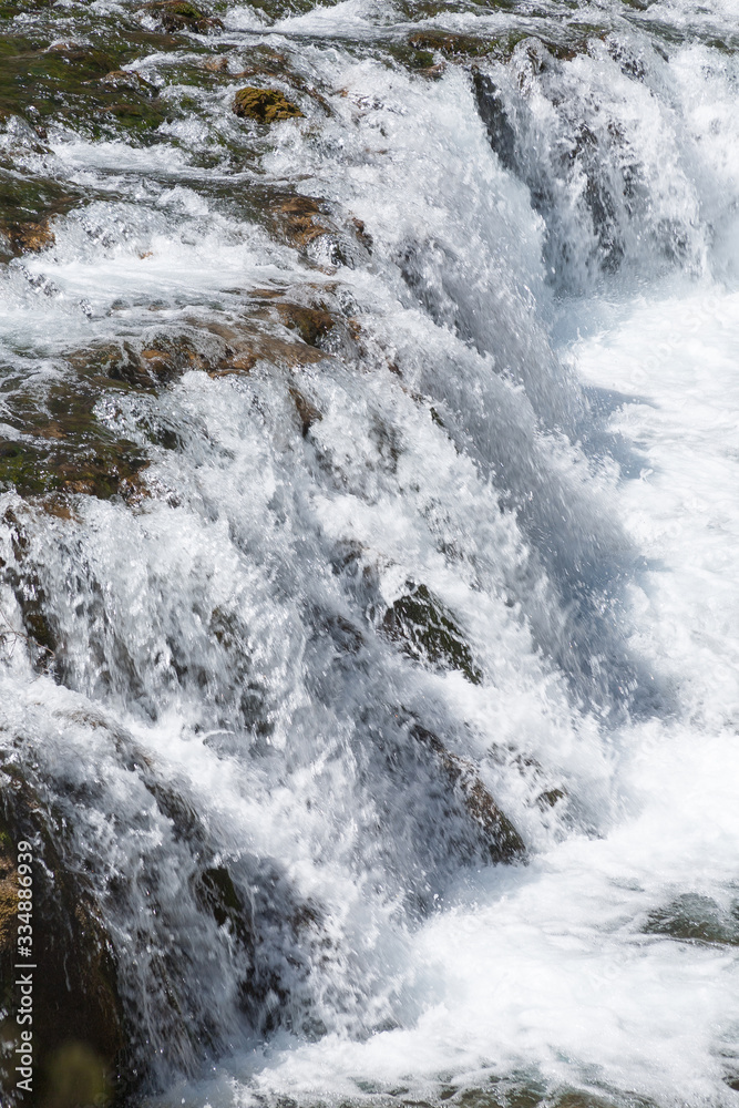 Small waterfall with clear turquoise water in Huancaya town, Lima Region, Peru