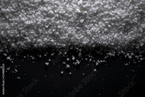 sea salt black Background of grains of salt crystals production. Heap of coarse salt