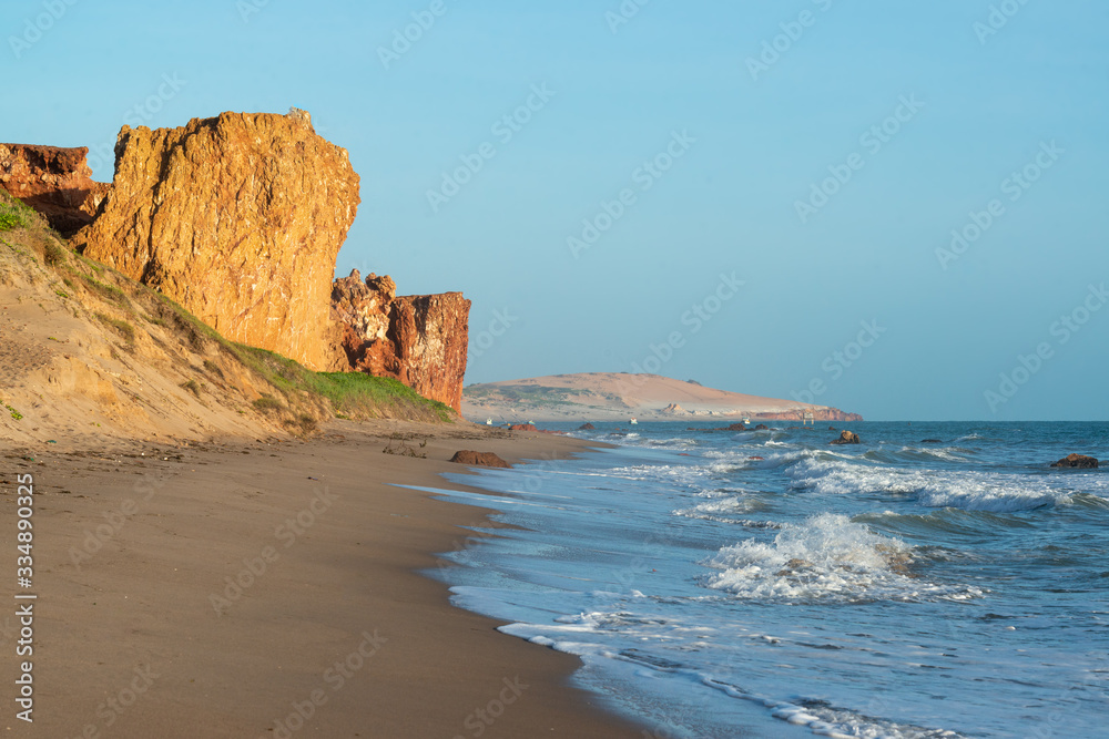 Cliff of colored sands, coconuts trees early in the morning on the beach of Peroba, Icapui, Ceará, Brazil on April 23, 2016
