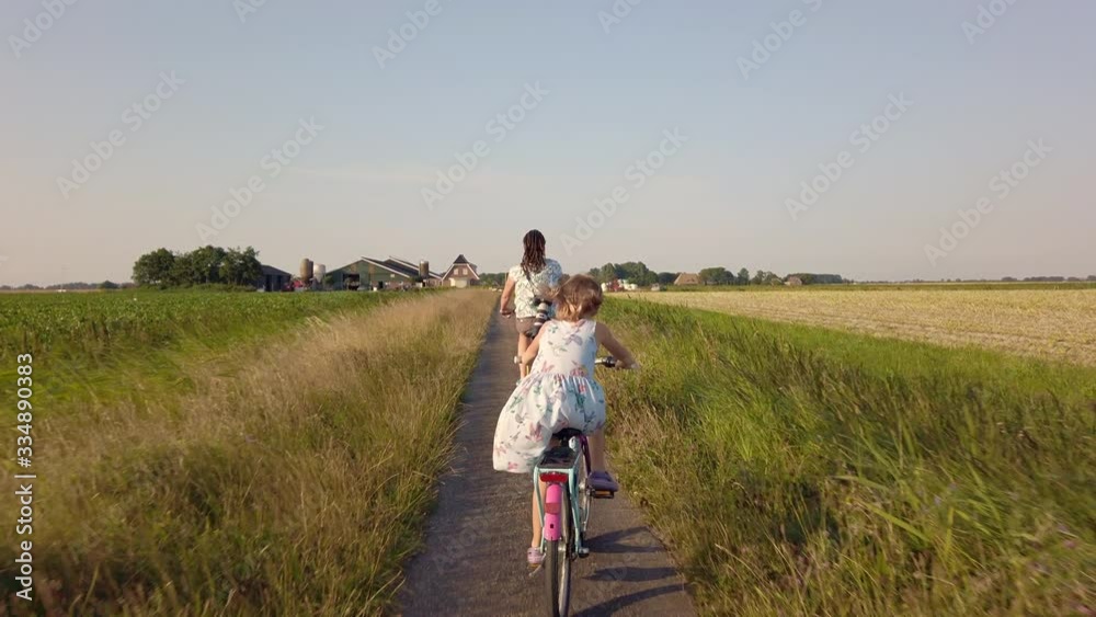 Mother and daughter cycling together, Netherlands Mother and daughter cycling together, Netherlands