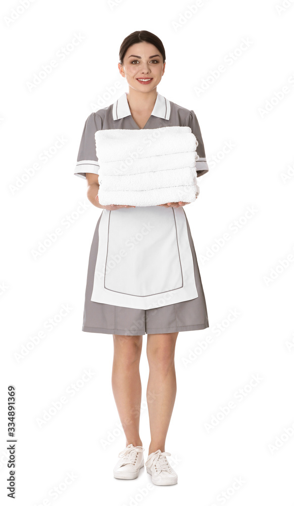 Young chambermaid holding stack of fresh towels on white background Young chambermaid holding stack of fresh towels on white background
