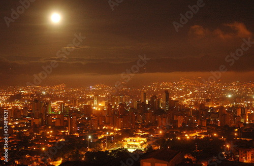 Sunrise with a full moon in Medellin Colombia.