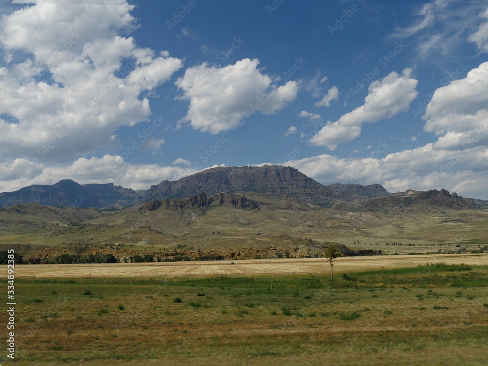 Wyoming landscape with mountains and rock formations in the distance.