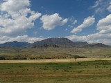 Wyoming landscape with mountains and rock formations in the distance.