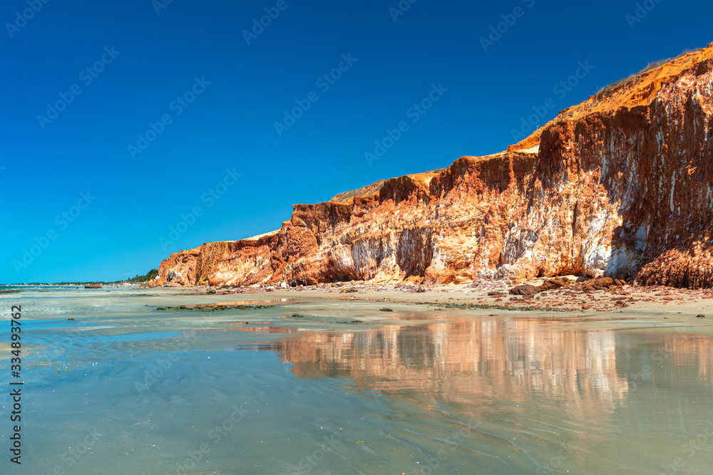 Colorful sand cliffs at the paradisiacal Praia de Vila Nova, Icapui, Ceara, Brazil on September 6, 2016