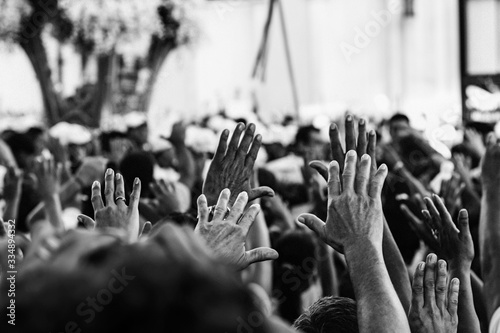 Mãos erguidas de pessoas. Multidão em procissão religiosa. Muitas mãos levantadas. photo