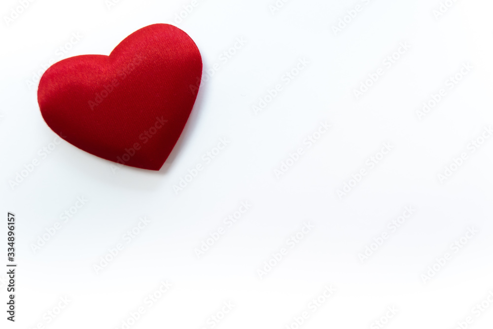 Red heart on white background, made from fabric. Copy space at bottom ...