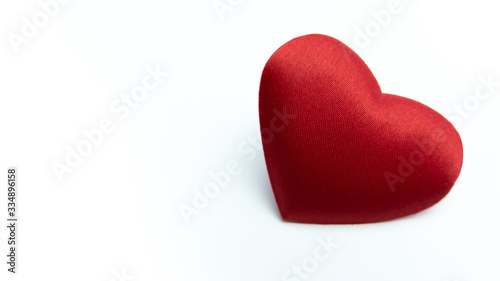 Romantic red heart on white background. Copy space at left with heart on right. photo