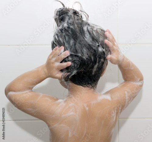 A girl washing her hair and body.