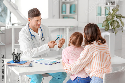 Woman with little daughter visiting pediatrician in clinic