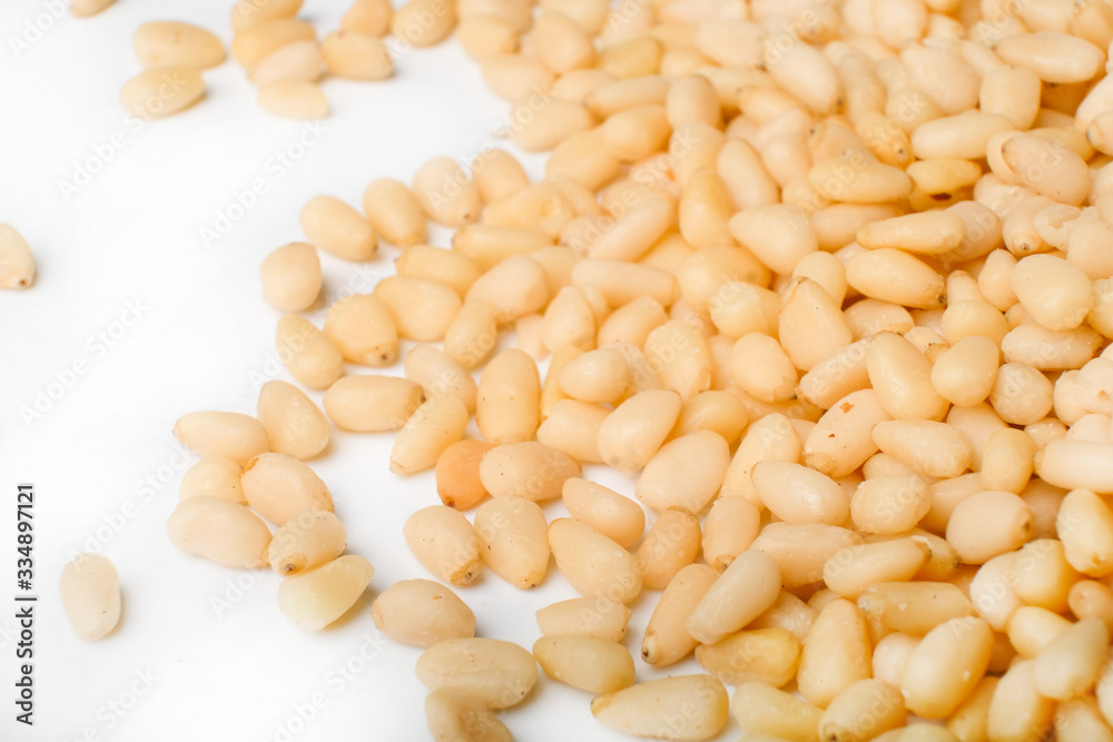 Fresh peeled cedar nuts isolated on white background, closeup Fresh peeled cedar nuts isolated on white background, closeup