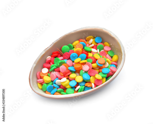 Sweet chocolate egg with sprinkles on white background