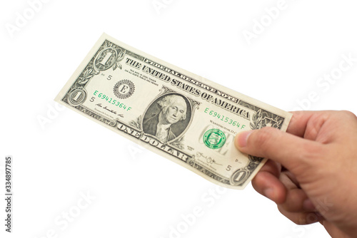 Hand holding one US Dollar isolated on white background.
