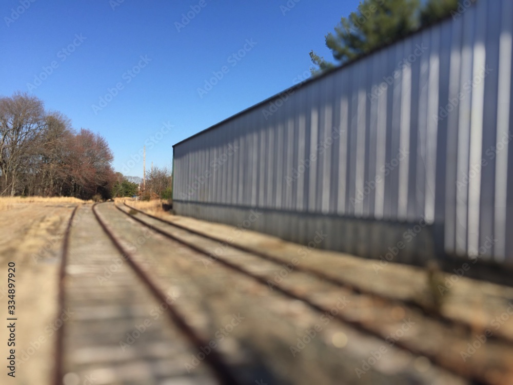 Obraz premium Railroad Track to Nowhere Along Side Abandoned Building in North Smithfield, Rhode Island RI USA Slatersville