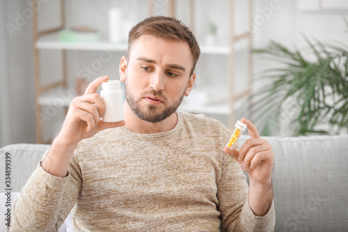 Young man with medicines at...