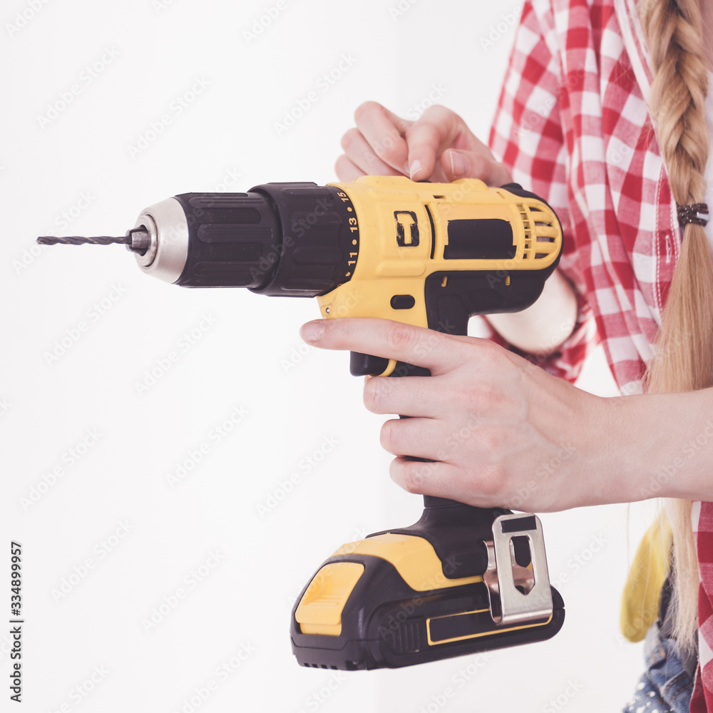 Hand holding yellow drill