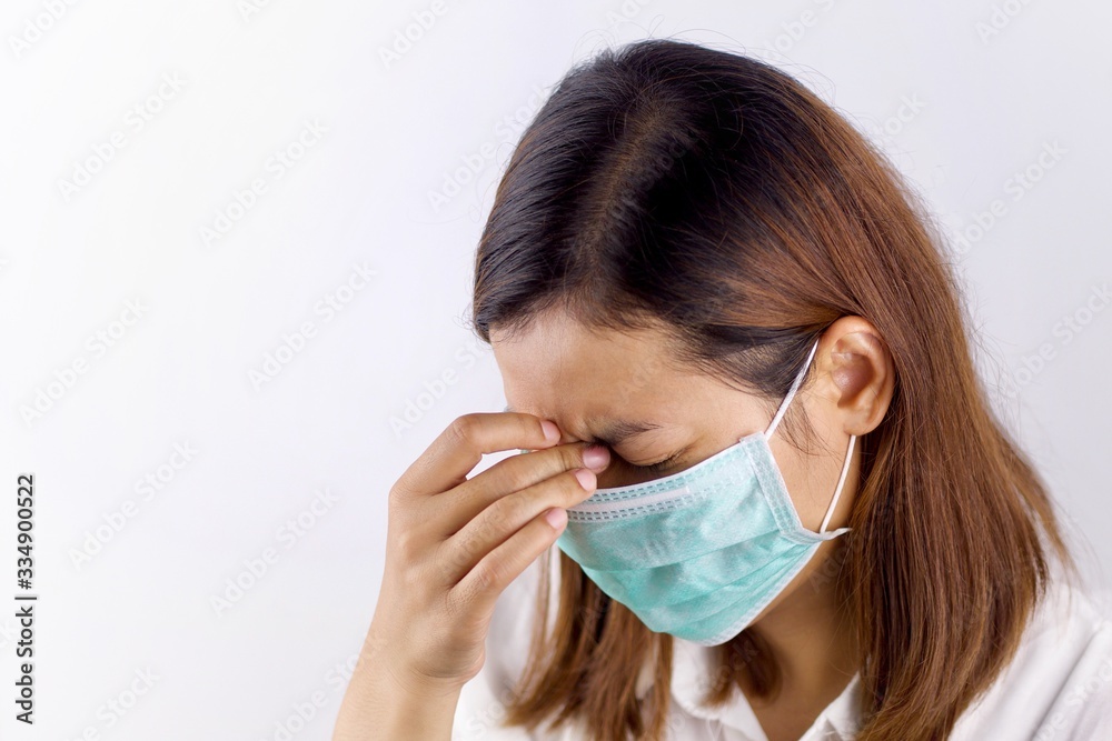 Health concepts, women wearing sanitary masks and handles in the head area She is sick and has a fever. Due to getting a virus or caused by a weak body. Health concepts, women wearing sanitary masks and handles in the head area She is sick and has a fever. Due to getting a virus or caused by a weak body.