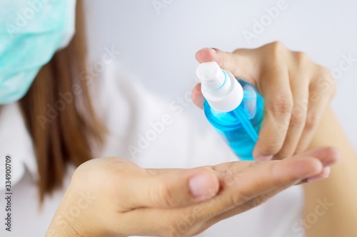 The girl's hand is cleaning her hands with Spay Alcohol. To get rid of various germs and viruses.