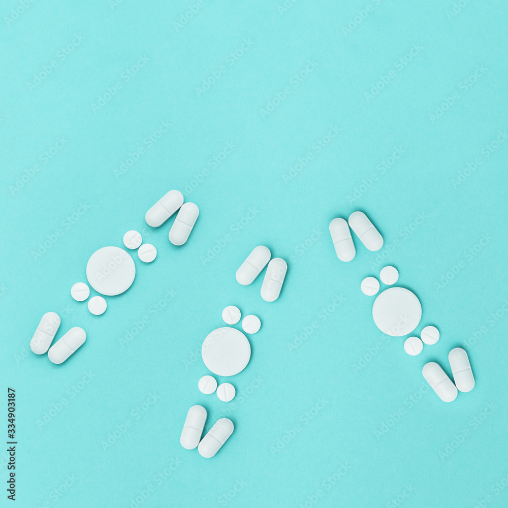 Pharmaceutical medicine pills white colored, tablets lie on mint colored paper fon in form of molecule, virus, or bacteria. Health care. Medical background. Flat lay. Copy space