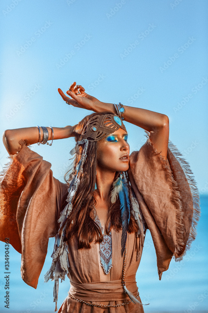 beautiful young woman in tribal costume outdoors portrait at sunset