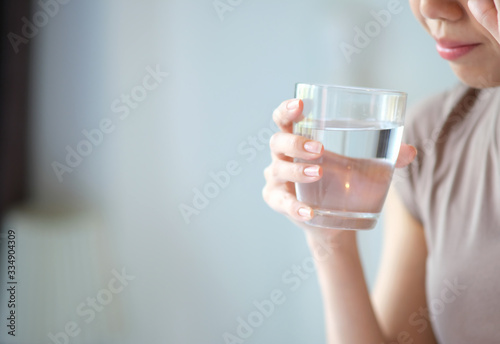 woman drinking glass of water and healthcare concept