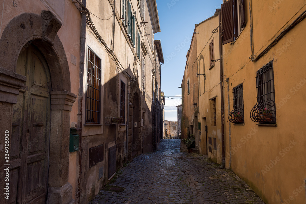 A narrow street between buildings in the historic town of Anguillara Sabazia in Italy