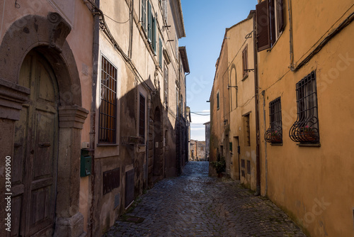 A narrow street between buildings in the historic town of Anguillara Sabazia in Italy