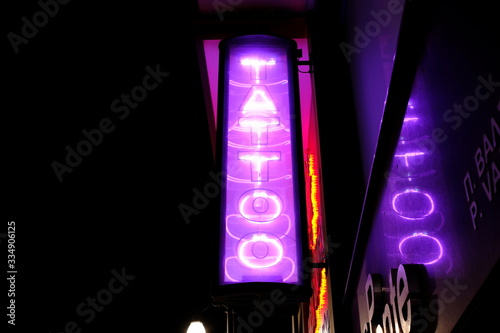 sign tattoo parlor at night in the city