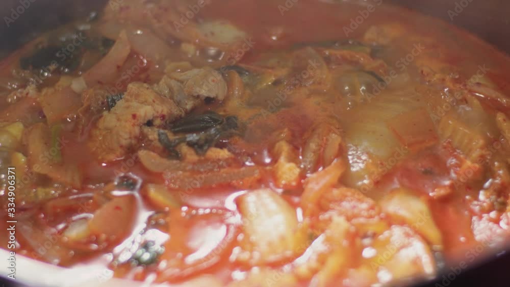 Home cooked Korean kimchi soup simmering. Close up, delicious spicy asian traditional food Home cooked Korean kimchi soup simmering. Close up, delicious spicy asian traditional food