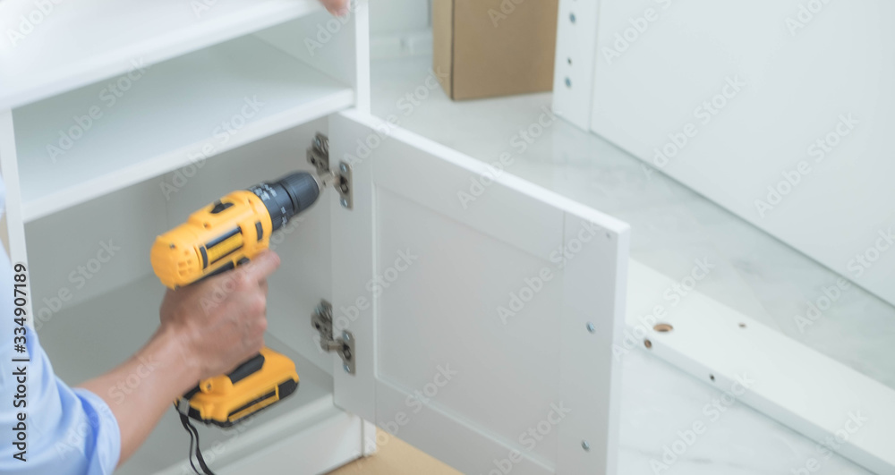 The mechanic assembled the furniture in the house according to the manual, along with the mechanic equipment. By hammering the nails Measuring with a tape measure Screwing the screw Drilling holes.