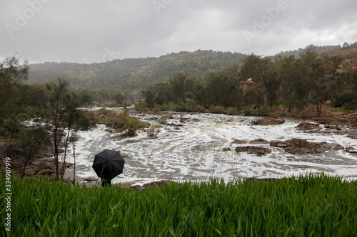 Stood in the rain watching the river flow