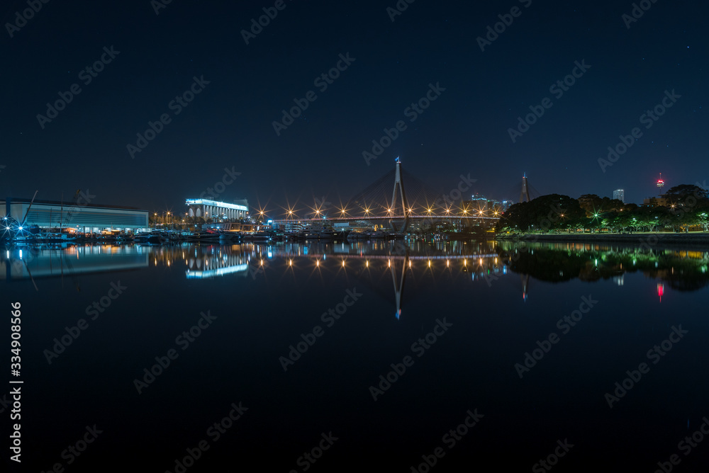Mirror reflections of Anzac bridge at night in Sydney, Australia
