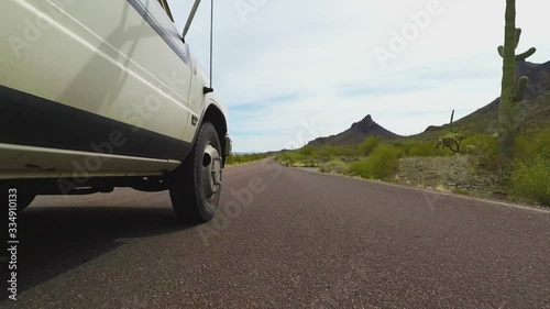Pickup Truck Past Cactus- Low Angle Side View