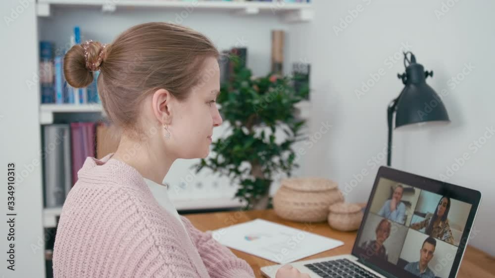 Online Group Video Call Conference of Work Team from Home Office. Woman Greets and Talks with 4 People at Video Chat using Laptop. Self-isolation at Coronavirus Pandemic. 4K Medium Orbit Shot Online Group Video Call Conference of Work Team from Home Office. Woman Greets and Talks with 4 People at Video Chat using Laptop. Self-isolation at Coronavirus Pandemic. 4K Medium Orbit Shot