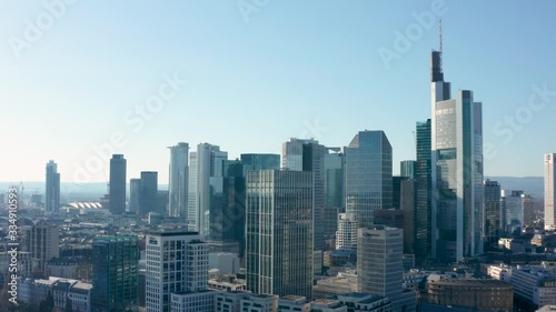 Skyline and skyscrapers of frankfurt am main with the river cinematic panorama fly away aerial drone shot 4K 25p photo