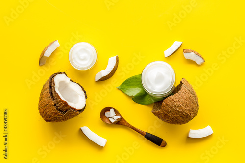 Homemade coconut cream - still life with spoon - on yellow background top-down