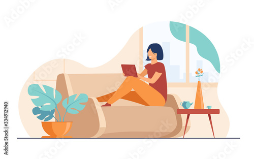 Young woman relaxing at sofa with laptop flat vector illustration. Lady sitting home and watching movie via computer. Digital technology and entertainment concept. photo