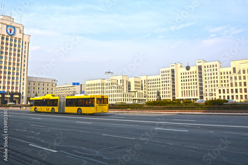 MINSK, BELARUS - MARCH 29 2020 :The House of the Government of the Republic of Belarus and yellow bus