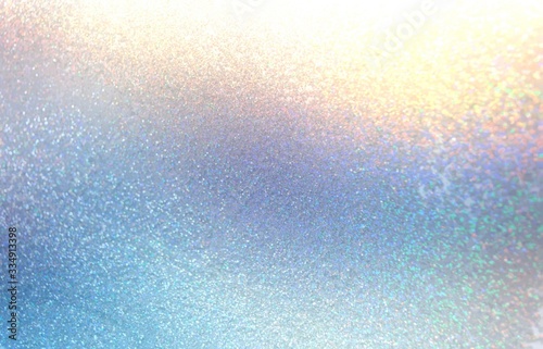 Blue yellow shimmer abstract pattern. Glitter texture. Winter holiday sparkles background. Iridescent gradient. Brilliance glare.