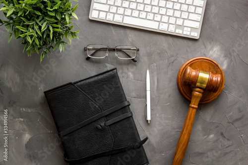 Judge gavel neart documents and keyboard - desk of contemporary lawyer - on grey background top-down photo