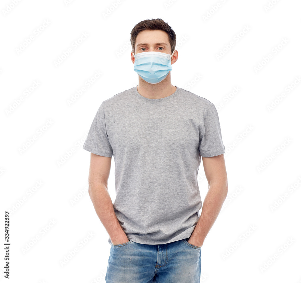 health, quarantine and pandemic concept - young man wearing protective medical mask for protection from virus disease over grey background health, quarantine and pandemic concept - young man wearing protective medical mask for protection from virus disease over grey background