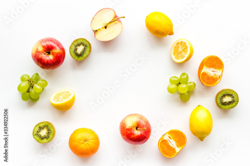 Colorful fruit mockup. Cut apple  kiwi  citrus on white background top-down copy space