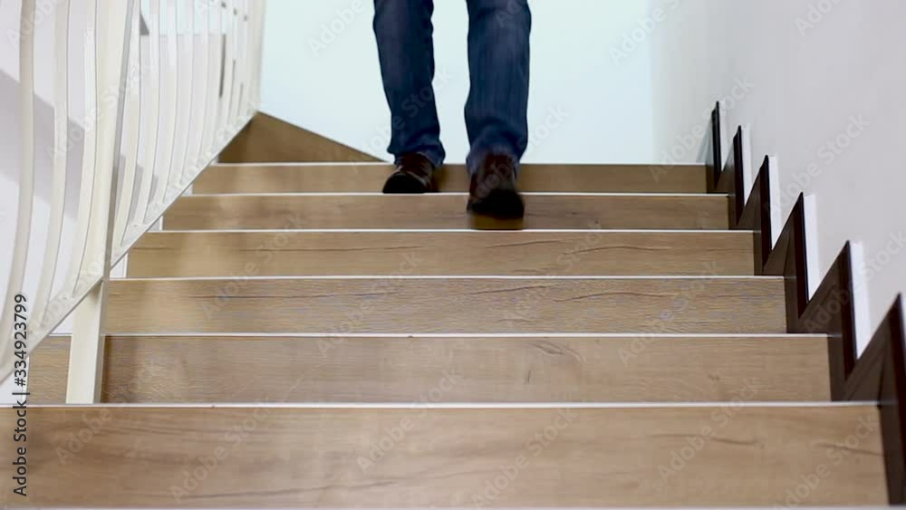man walking down to floor below