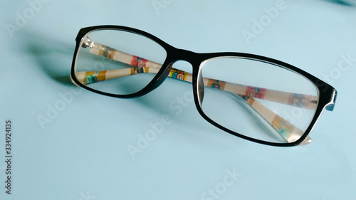 eyeglasses with black frames on a blue background