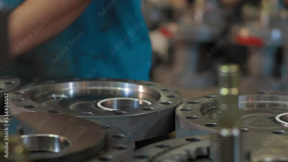 Engineer checks quality Parts of wellhead fittings and butterfly valves. Oil and Gas Wellhead tree equipment production plant. Equipment for wellhead conncetion of oil and gas wells.Dolly shot