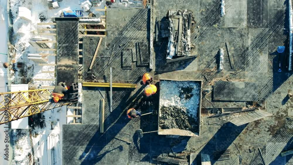 Building construction, construction industry. Engineers in uniform work on a building site.